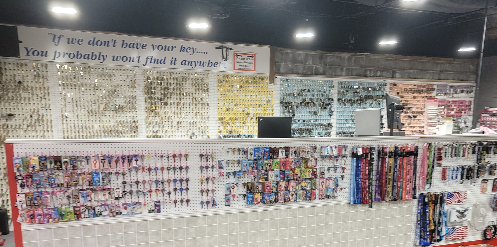 Thousands of key blanks on the wall inside the shop, beneath the sign reading If we don't have your key you probably won't find it anywhere